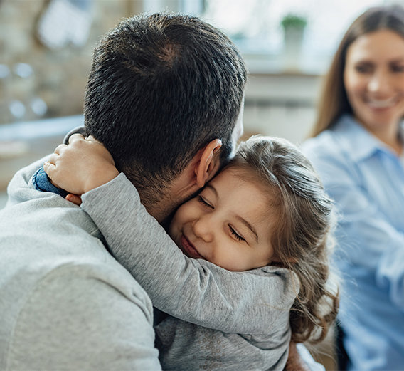 Daughter hugging father